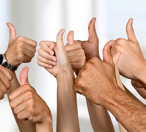 Group of hands giving the "thumbs up" sign of approval. Indicating the testimonials are very good.