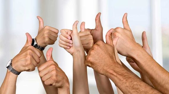 Group of hands giving the "thumbs up" sign of approval. Indicating the testimonials are very good.