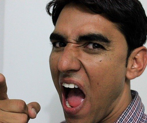 Angry man yelling and pointing his finger