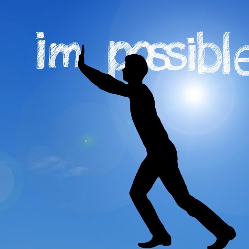 Silhouette of man in front of the word "impossible", pushing the letters apart to read "im possible". Image by Gerd Altmann from Pixabay.